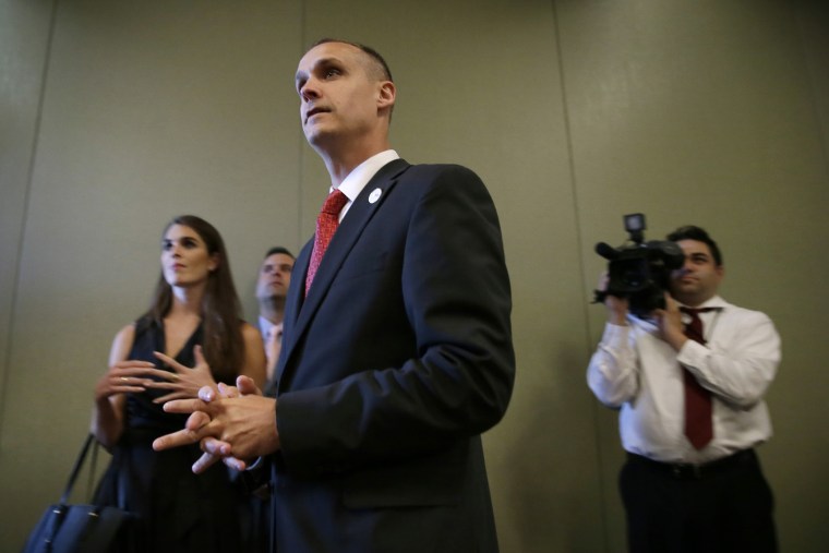 In this photo taken Aug. 25, 2015, Republican presidential candidate Donald Trump's campaign manager Corey Lewandowski watches as Trump speaks in Dubuque, Iowa. (Photo by Charlie Neibergall/AP)