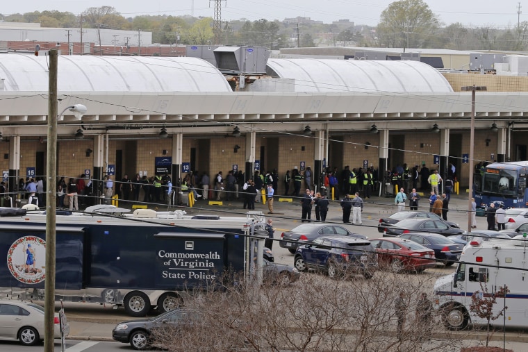 Police and rescue officials mingle with bus patrons outside the Greyhound Bus Station, March 31, 2016, in Richmond, Va. (Photo by Steve Helber/AP)