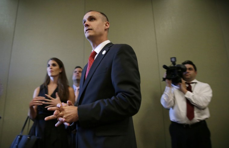 In this photo taken Aug. 25, 2015, Republican presidential candidate Donald Trump's campaign manager Corey Lewandowski watches as Trump speaks in Dubuque, Ia. (Photo by Charlie Neibergall/AP)