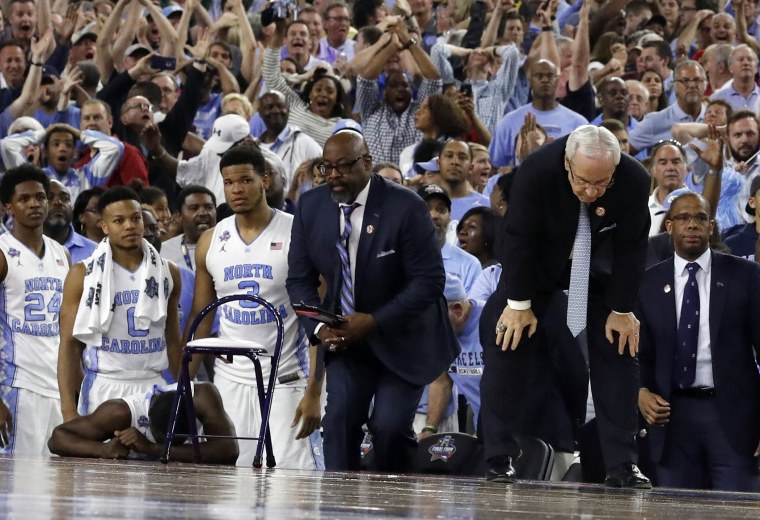 North Carolina head coach Roy Williams, right and his players on the bench react after the Villanova game winning three pointer at the NCAA Final Four tournament college basketball championship game against Villanova, April 4, 2016, in Houston.