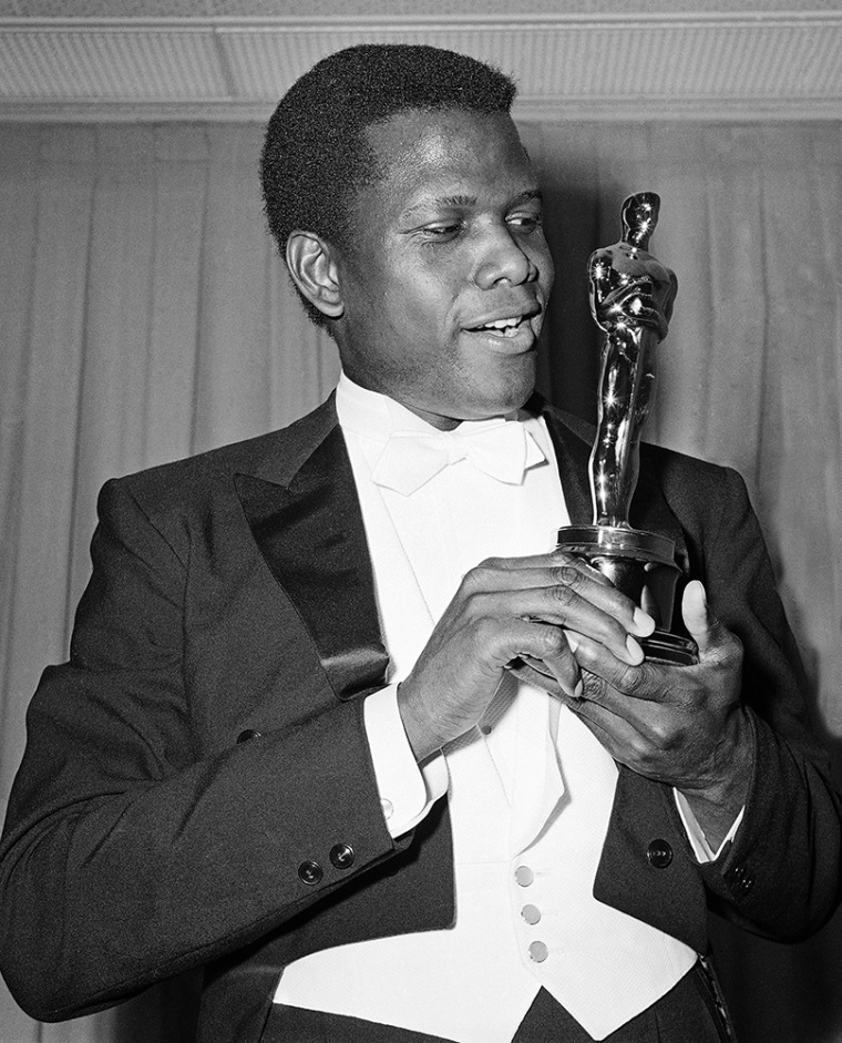 Actor Sidney Poitier is photographed with his Oscar statuette at the 36th Annual Academy Awards in Santa Monica, Calif. on April 13, 1964. He won Best Actor for his role in \"Lillies of the Field.\" (Photo by AP)