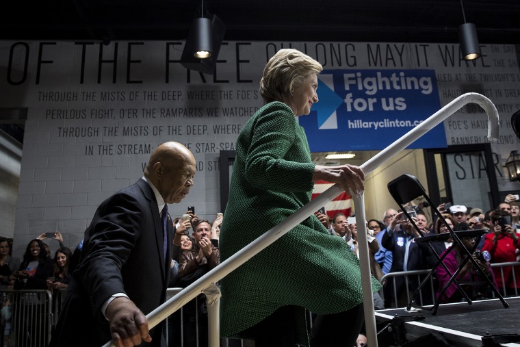 Representative Elijah Cummings (D-Md.) and Hillary Clinton, 2016 Democratic presidential candidate, arrive on stage at the start of an event in Baltimore, Md., April 10, 2016. (Photo by Drew Angerer/Bloomberg/Getty)