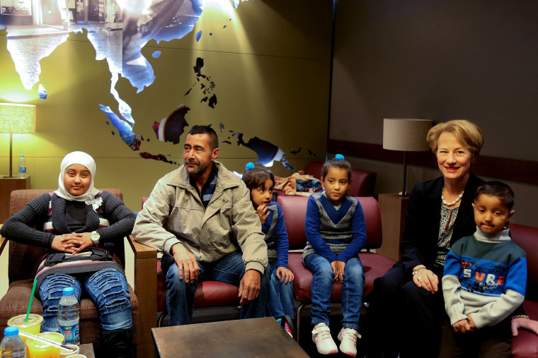 U.S. Ambassador to Jordan Alice Wells, right, meets with Syrian refugee Ahmad al-Abboud, center, and his family at the International Airport of Amman, Jordan, April 6, 2016. (Photo by Raad Adayleh/AP)