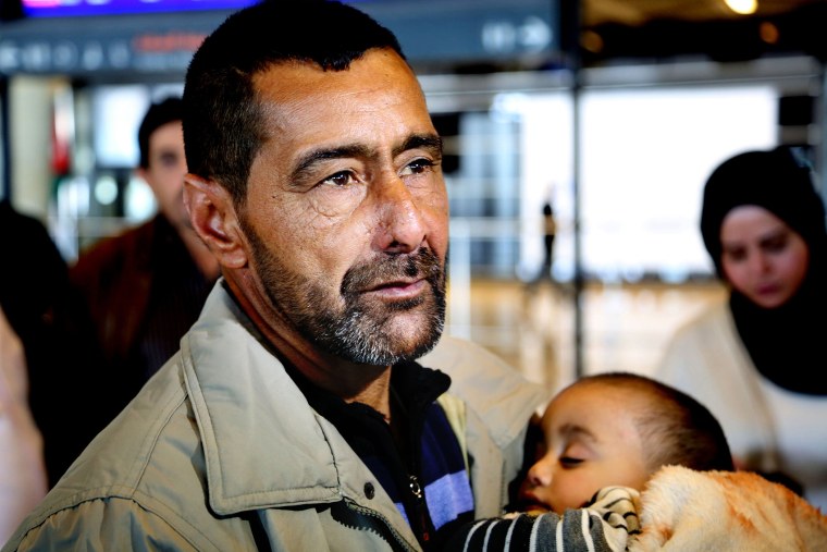 Syrian refugee Ahmad al-Abboud waits with his family at the International Airport of Amman, Jordan, April 6, 2016. (Photo by Raad Adayleh/AP)