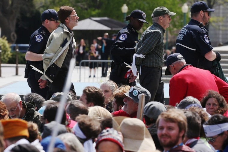 U.S. Capitol Police arrest Democracy Spring protesters participating in a sit-in at the Capitol to protest big money in politics, April 11, 2016 in Washington, DC. (Photo by Mark Wilson/Getty)