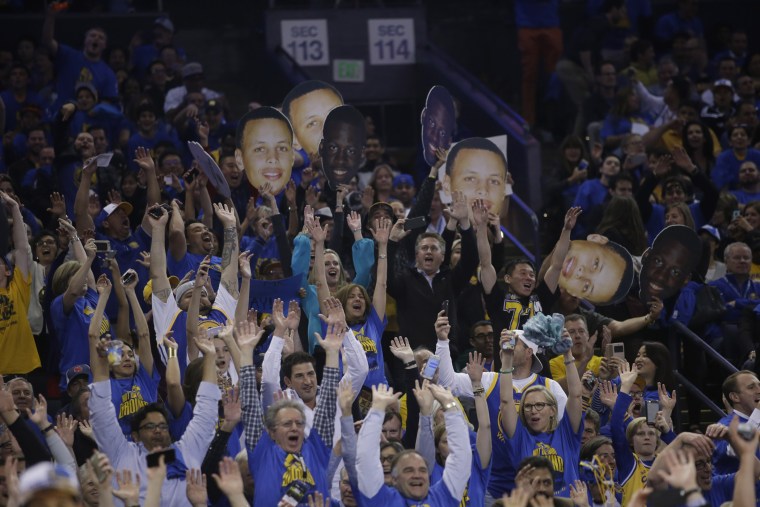 Fans do the wave as the Golden State Warriors jump ahead of the Memphis Grizzlies during the second half of an NBA basketball game, April 13, 2016, in Oakland, Calif. (Photo by Marcio Jose Sanchez/AP)