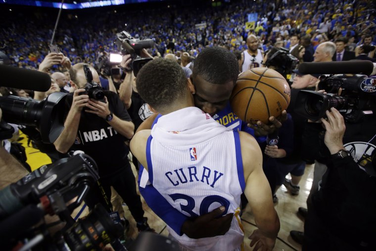 Golden State Warriors' Stephen Curry, front, is hugged by teammate Draymond Green after a 125-104 win over the Memphis Grizzlies during an NBA basketball game, April 13, 2016, in Oakland, Calif. (Photo by Marcio Jose Sanchez/AP)
