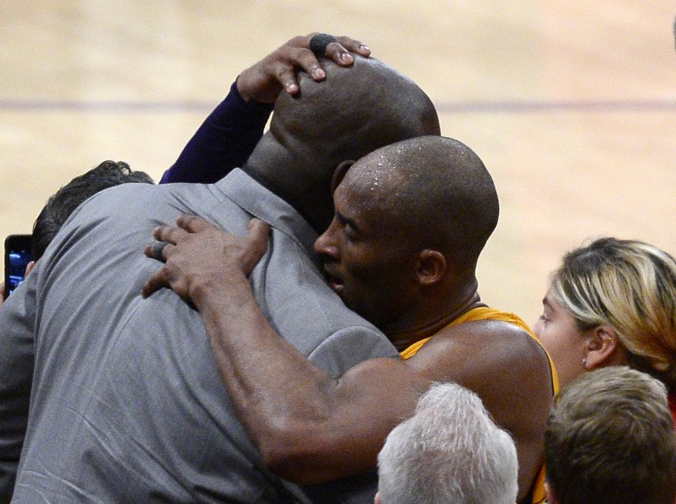 Kobe Bryant #24 of the Los Angeles Lakers hugs former teammate Shaquille O'Neal after retiring from basketball scoring 60 points against the Utah Jazz at Staples Center on April 13, 2016 in Los Angeles, Calif. (Photo by Kevork Djansezian/Getty)