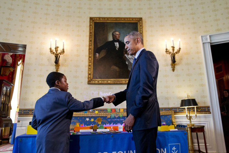 President Barack Obama gives a fist bump to Jacob Leggette, 9, of Baltimore, Md., who creates toys using a 3D printer, while touring the 2016 White House Science Fair at the White House in Washington, D.C., April 13, 2016. (Photo by Jacquelyn Martin/AP)