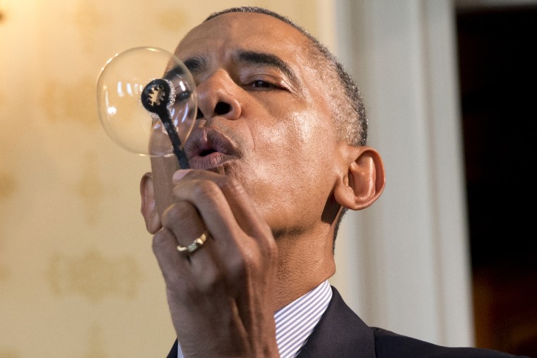 President Barack Obama blows a soap bubble using a 3-D printed bubble wand designed by Jacob Leggette, 9, of Baltimore, Md., while touring the 2016 White House Science Fair at the White House in Washington, D.C., April 13, 2016. Photo by Jacquelyn Martin