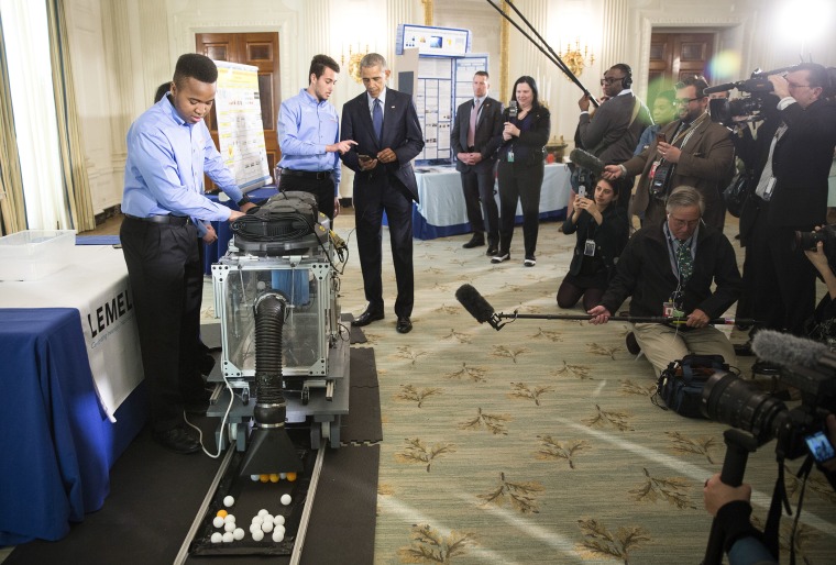 President Barack Obama talks with a team of young engineers from New York about their subway rail vacuum during the 2016 White House Science Fair in the State Dining Room of the White House in Washington, D.C., April 13, 2016.