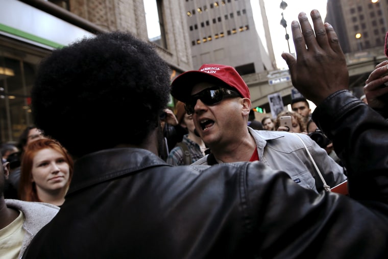 A supporter of Republican presidential candidate Donald Trump (in red hat) screams at protesters demonstrating against Donald Trump in midtown Manhattan in New York City, April 14, 2016. (Photo by Mike Segar/Reuters)