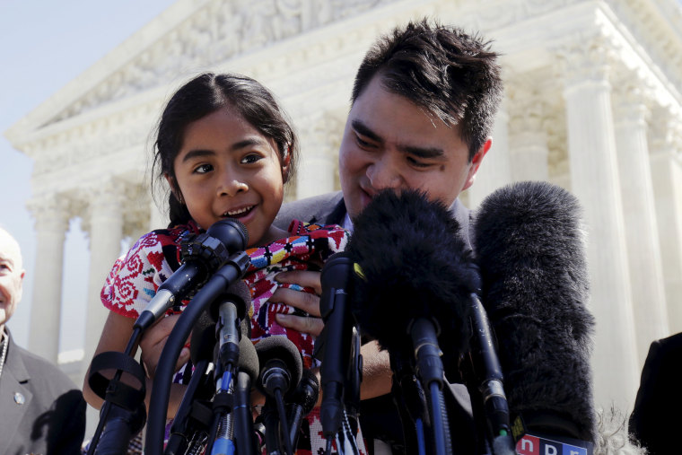 Sophie Cruz, 6, is held as she speaks after arguments on immigration were heard at the Supreme Court in Washington, April 18, 2016. (Photo by Joshua Roberts/Reuters)