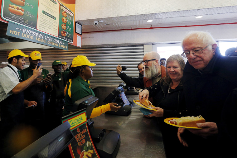 Democratic presidential candidate and U.S. Senator Bernie Sanders (R), his wife Jane (2nd R) and musician Michael Stipe (3rd R) order hot dogs at Nathan's Famous in Coney Island, New York, April 10, 2016. (Photo by Bryan Snyder/Reuters)