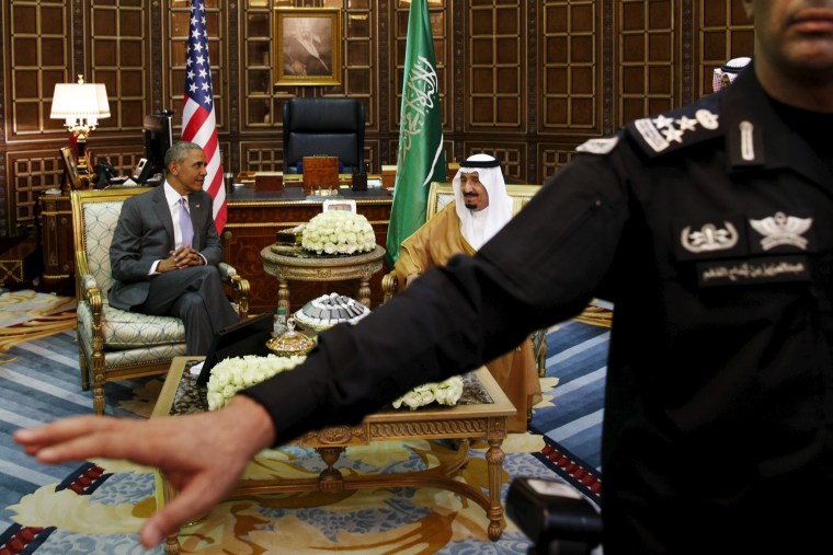 A guard ushers away photographers as President Barack Obama meets with Saudi King Salman at Erga Palace upon his arrival for a summit meeting in Riyadh, Saudi Arabia, April 20, 2016. (Photo by Kevin Lamarque/Reuters)