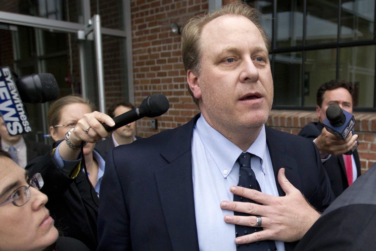 In this May 16, 2012, file photo, former Boston Red Sox pitcher Curt Schilling, center, is followed by members of the media as he departs the Rhode Island Economic Development Corporation headquarters, in Providence, R.I. (Photo by Steven Senne/AP)