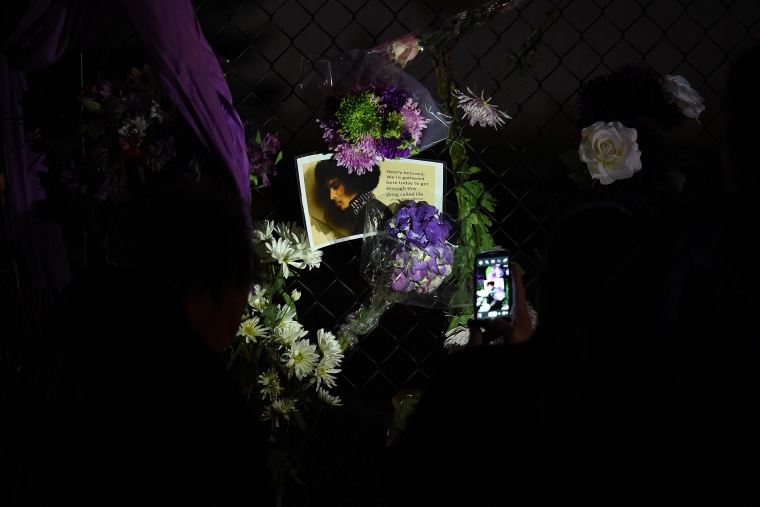 Fans pay their respects outside the Paisley Park residential compound of music legend Prince in Minneapolis, Minn., on April 21, 2016. (Photo by Mark Ralston/AFP/Getty)