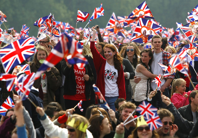 Spectators wave their flags in Hyde Park where big screens have been set up to watch the wedding ceremony on April 29, 2011 in London, England. (Photo by Tom Dulat/Getty)