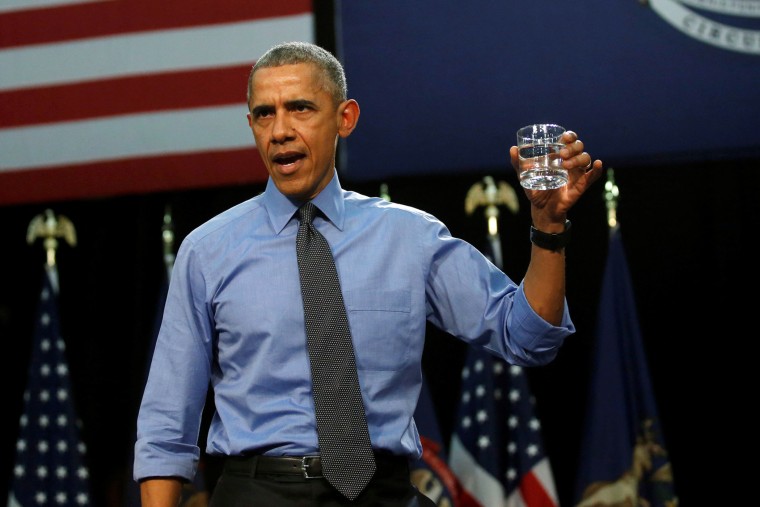 President Barack Obama drinks a glass of filtered water from Flint, a city struggling with the effects of lead-poisoned drinking water, as he delivers remarks at North Western High School in Mich., May 4, 2016. (Photo by Carlos Barria/Reuters)