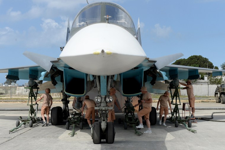 Russian servicemen prepare an SU-34 fighter jet for a mission from the Russian Hmeimim military base in Latakia province, in the northwest of Syria on May 4, 2016. (Photo by Vasily Maximov/AFP/Getty)