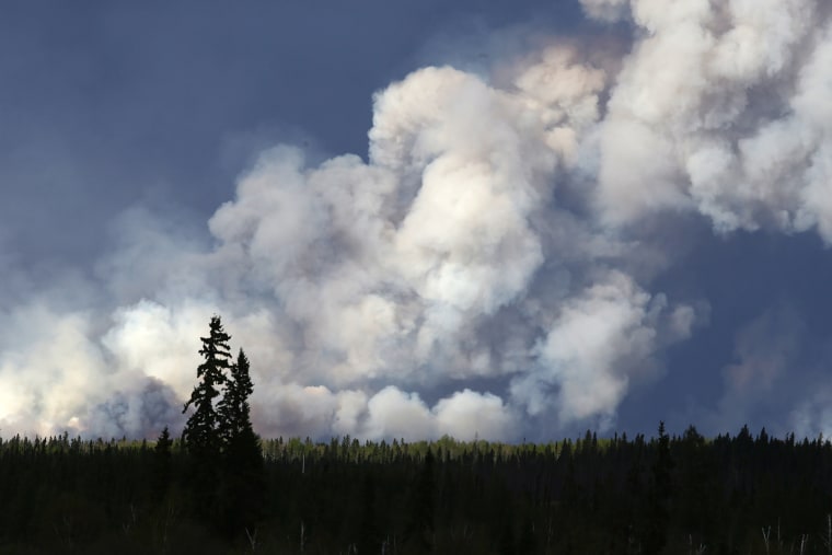Smoke billows in the sky near Fort McMurray, Alberta, on May 5, 2016. (Photo by Cole Burston/AFP/Getty)