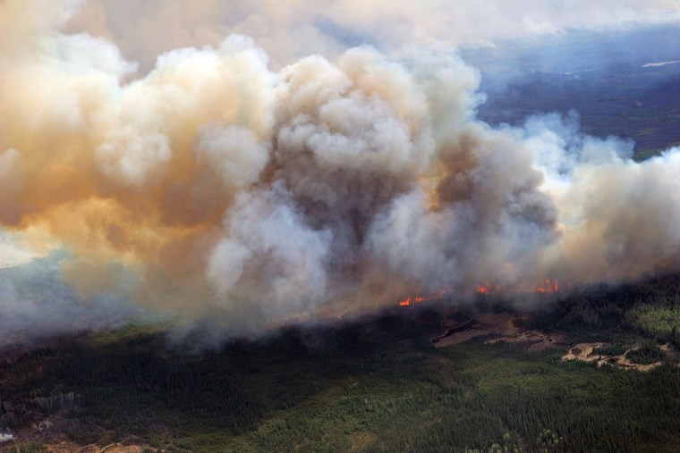 A handout photo provided by the Canadian Armed Forces on May 5, 2016 shows a view of the wildfires in the Fort McMurray, Alberta, Canada, on May 4, 2016. (Photo by MCpl Van Putten/Canadian Armed Forces/Handout/EPA)