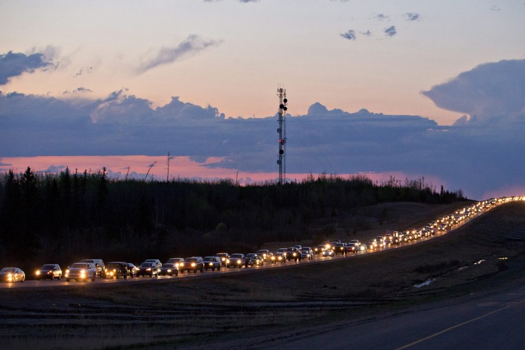 Traffic lines the highway as residents leave Fort McMurray, Alberta, Canada, on May 3, 2016. (Photo by Jason Franson/The Canadian Press/AP)