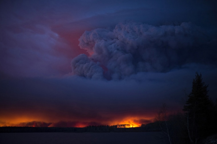 A massive wildfire, which caused a mandatory evacuation, rages south of Fort McMurray near Anzac, Alberta, Canada May 4, 2016. (Photo by Chris Schwarz/Government of Alberta/Handout/Reuters)