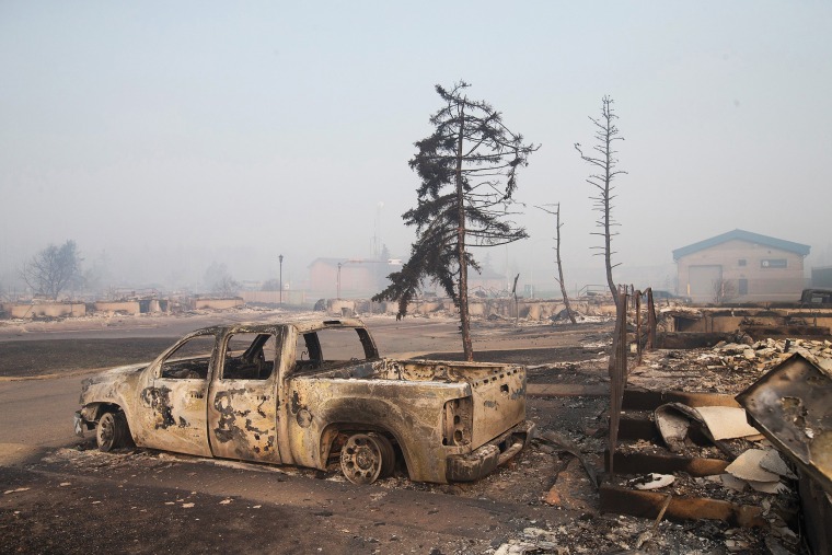 Home foundations and shells of vehicles are nearly all that remain in a residential neighborhood destroyed by a wildfire on May 6, 2016 in Fort McMurray, Alberta, Canada. (Photo by Scott Olson/Getty)