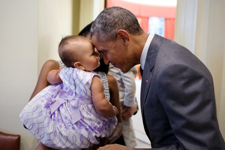 President Barack Obama greets nine-month-old Josephine Gronniger outside the Oval Office of the White House, July 17, 2015 in Washington, DC. (Photo by Pete Souza/Official White House Photo/Planet Pix/ZUMA)