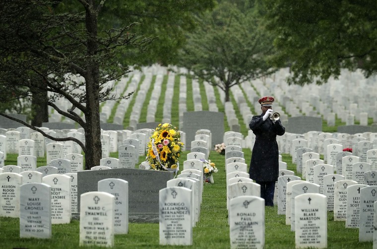 A bugler plays 'Taps' during a funeral at Arlington National Cemetery May 6, 2016 in Arlington, Va. (Photo by Alex Wong/Getty)