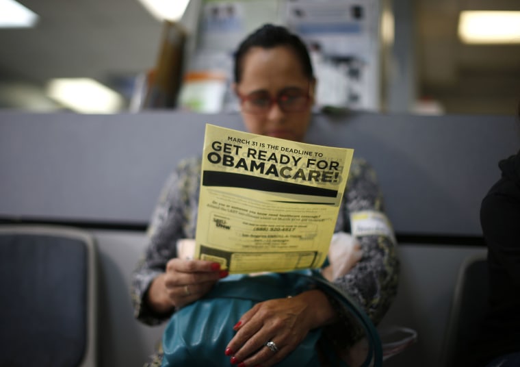 Arminda Murillo, 54, reads a leaflet at a health insurance enrollment event in Cudahy, Calif., March 27, 2014. (Photo by Lucy Nicholson/Reuters)
