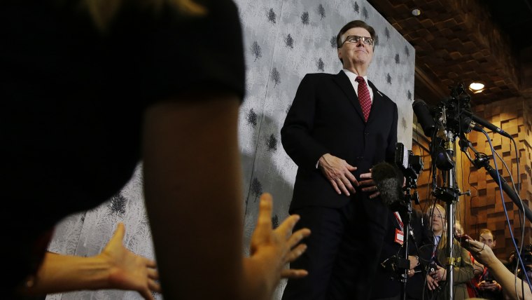 Texas Lt. Gov. Dan Patrick, right, listens to a reporter's question during a news conference at the Texas Republican Convention Friday, May 13, 2016, in Dallas. (Photo by LM Otero/AP)
