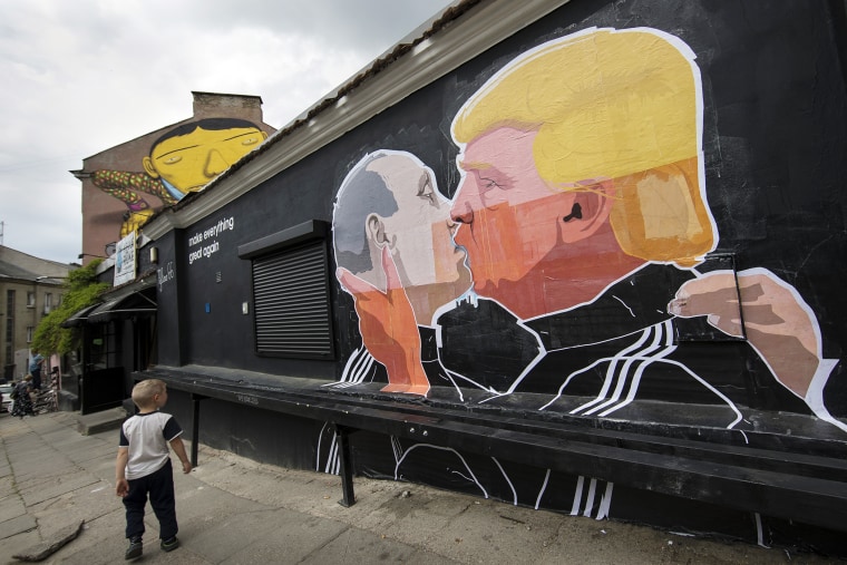 A child walks past a graffiti depicting Russian President Vladimir Putin and Republican presidential candidate Donald Trump on the walls of a bar in the old town in Vilnius, Lithuania, May 14, 2016. (Photo by Mindaugas Kulbis/AP)