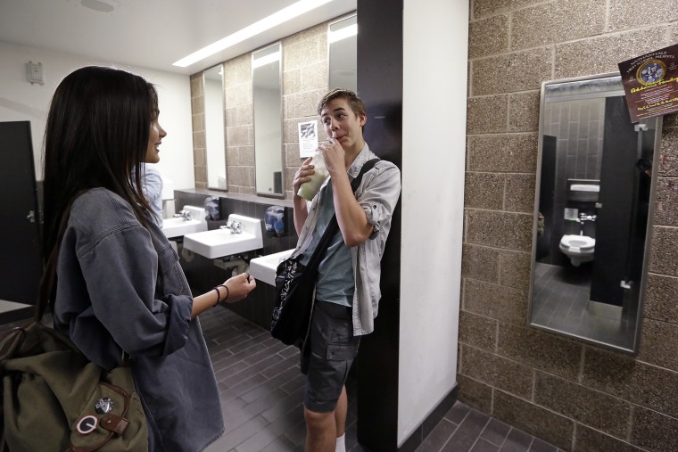 Ninth graders Tehya Vining, left, and Christian Jarboe talk after walking for the first time into a gender neutral bathroom at Nathan Hale high school, May 17, 2016, in Seattle. (Photo by Elaine Thompson/AP)