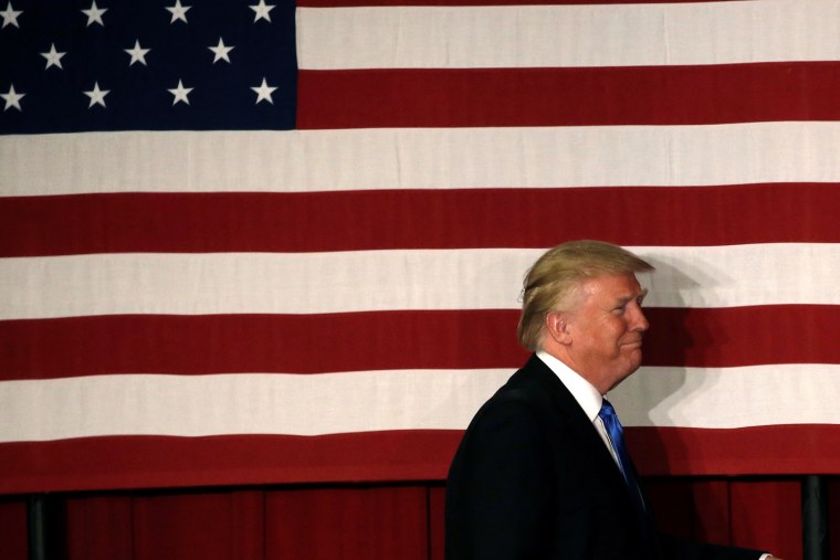 U.S. Republican presidential candidate Donald walks to the stage past an American flag at a fundraising event where he appeared with New Jersey Governor Chris Christie in Lawrenceville, N.J., May 19, 2016. (Photo by Mike Segar/Reuters)