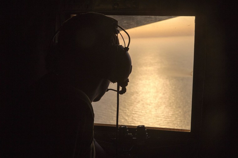 A British Navy officer looks out the window of an Royal Air Force C-130 Hercules aircraft in the search and rescue operations for the missing EgyptAir flight MS804, May 19, 2016. (Photo by Helen Rimmer/British Ministry of Defense/EPA)