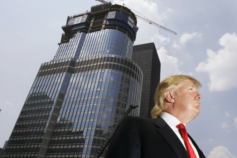 Donald Trump is profiled against his 92-story Trump International Hotel & Tower during a news conference on construction progress in Chicago, Ill. on May 24, 2007. (Photo by Charles Rex Arbogast/AP)