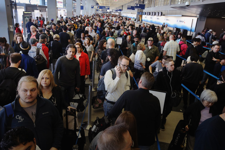 Passengers at O'Hare International Airport wait in line to be screened at a Transportation Security Administration (TSA) checkpoint on May 16, 2016 in Chicago, Ill. (Photo by Scott Olson/Getty)
