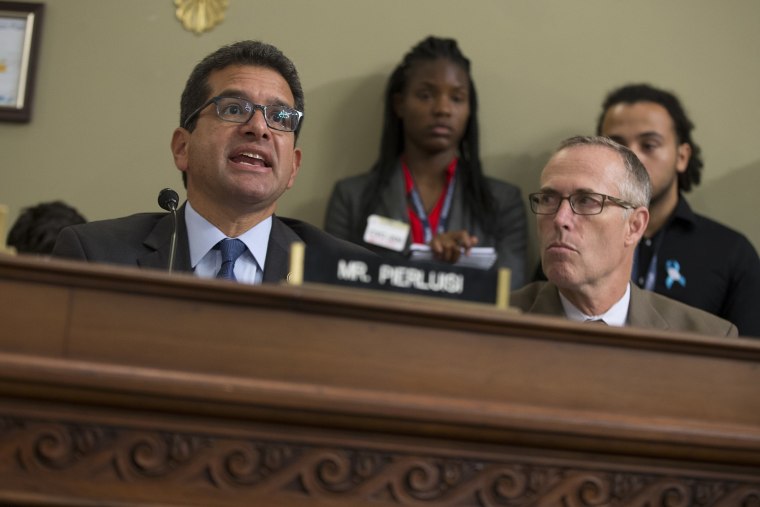 Rep. Jared Huffman, D-Calif. listens at right as Puerto Rico's Resident Commission Pedro Pierluisi, D-Puerto Rico, speaks on Capitol Hill in Washington, May 25, 2016. (Photo by Evan Vucci/AP)