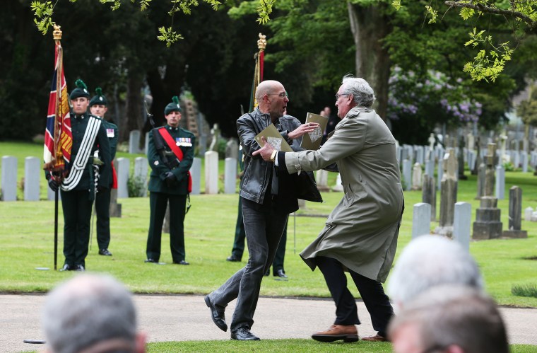 Canadian Ambassador to Ireland Kevin Vickers wrestles with a protester during a State ceremony to remember the British soldiers who died during the Easter Rising in Dublin, May 26, 2016. (Photo by Brian Lawless/PA Wire/AP)