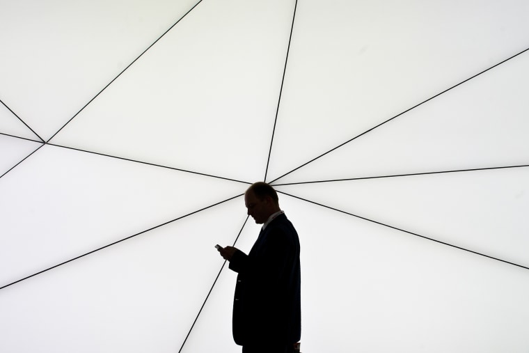 A man checks his mobile phone on Feb. 25, 2013 in Barcelona, Spain. (Photo by David Ramos/Getty)