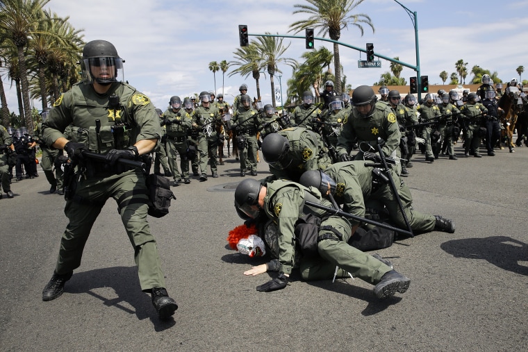 Orange County Sheriff's deputies take a protester into custody near the Anaheim Convention Center, May 25, 2016, in Anaheim, Calif. Republican presidential candidate Donald Trump held a rally at the convention center. (Photo by Jae C. Hong/AP)