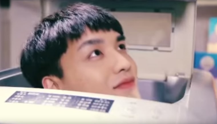 Screenshot of \"clean man\" character poking his head out of a washing machine during a commercial by Chinese laundry brand Qiaobi. (Photo via Youtube/NBC News)