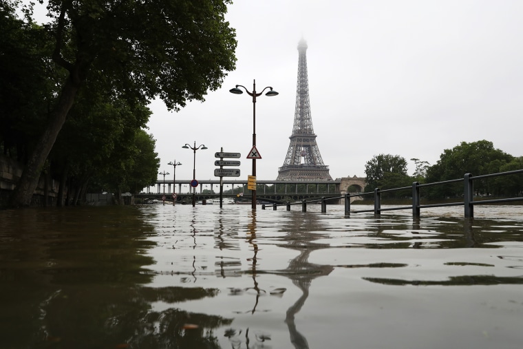 A picture taken on June 2, 2016 shows the river Seine bursting its banks next to the Eiffel Tower in Paris. (Photo by Kenzo Tribouillard/AFP/Getty)