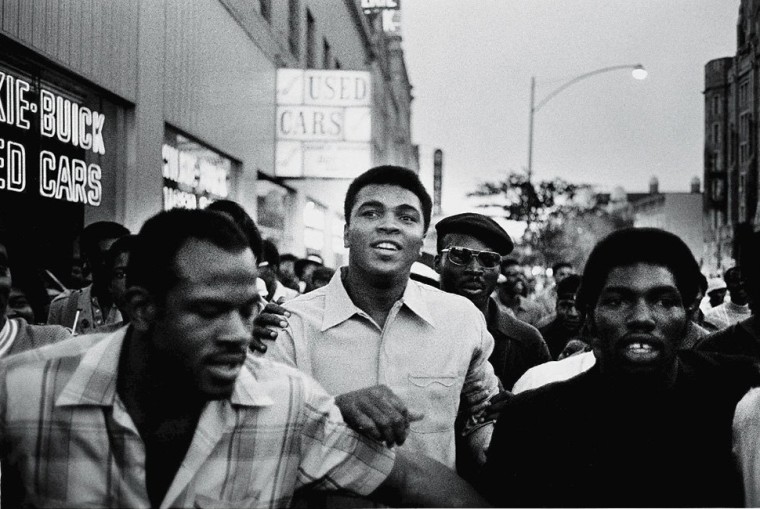 Heavyweight boxing champion Muhammad Ali walks through the streets with members of the Black Panther Party in New York, N.Y. in Sept. of 1970. (Photo by David Fenton/Getty)