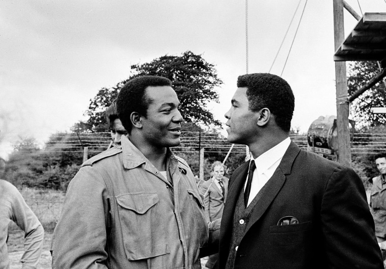 In this Aug. 5, 1966 photo, heavyweight boxer Muhammad Ali, right, visits Cleveland Browns running back and actor Jim Brown on the film set of \"The Dirty Dozen\" at Morkyate, Bedfordshire, England.