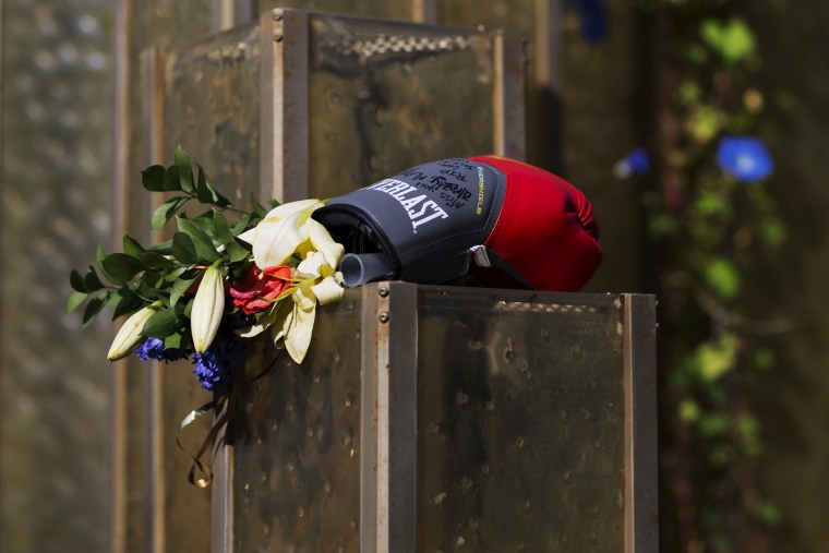 Flowers and a boxing glove are left at a makeshift memorial to Muhammad Ali at the Muhammad Ali Center, June 6, 2016, in Louisville, Ky. (Photo by David Goldman/AP)