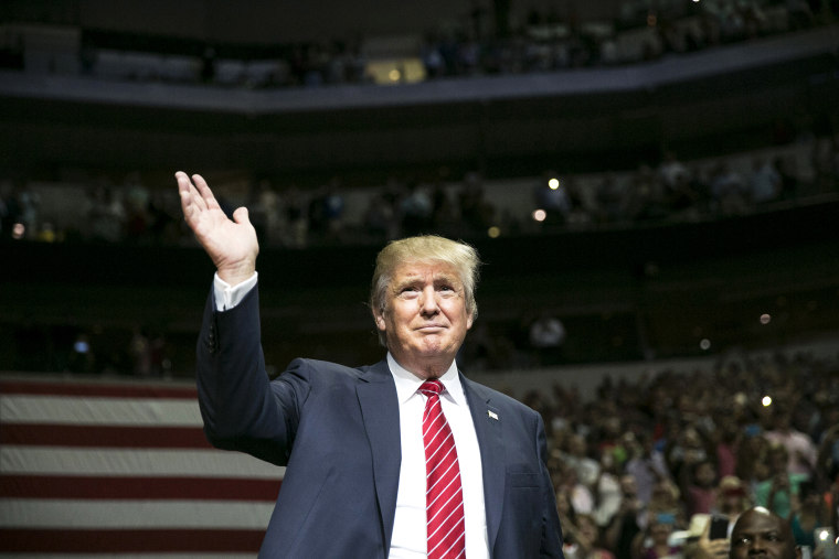 Republican presidential candidate Donald Trump waves during a campaign rally at the American Airlines Center in Dallas, Texas on Sept. 14, 2015. (Photo by Laura Buckman/AFP/Getty)