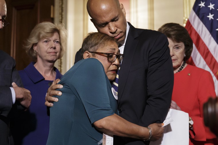 Rev. Sharon Risher is embraced by Sen. Cory Booker, D-N.J., during a news conference calling for gun control legislation, June 16, 2016, on Capitol Hill in Washington. (Photo by J. Scott Applewhite/AP)